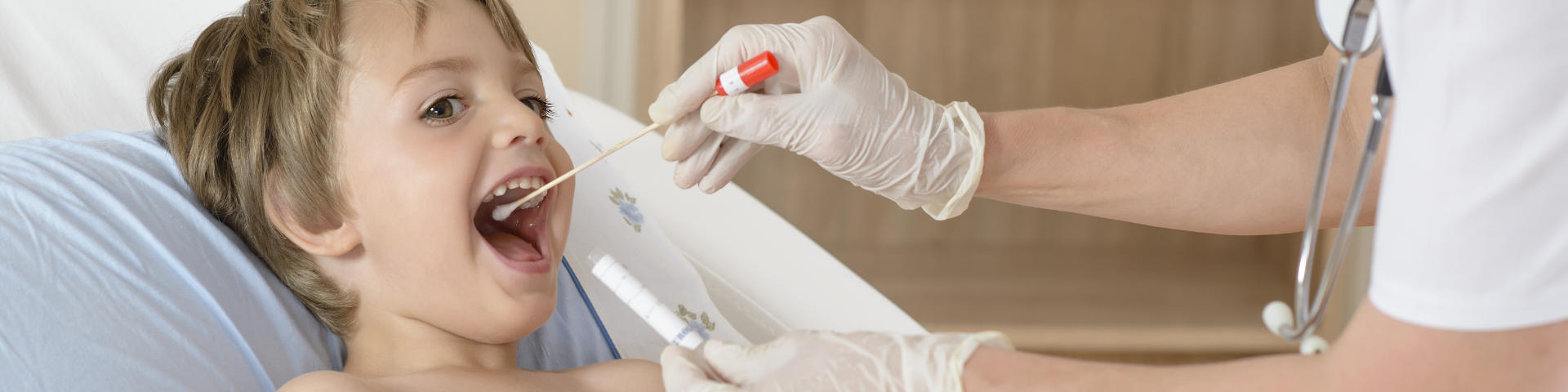 a child having flue and strep test taken by a doctor